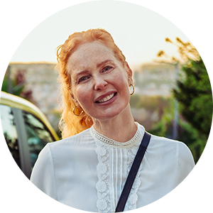 Portrait einer Frau mittleren Alters mit roten Haaren.